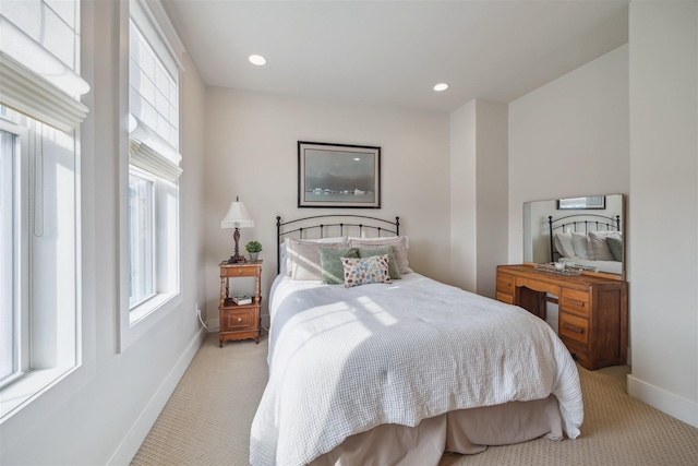 bedroom featuring recessed lighting, light colored carpet, and baseboards