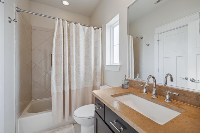 bathroom with shower / bath combo with shower curtain, toilet, and vanity