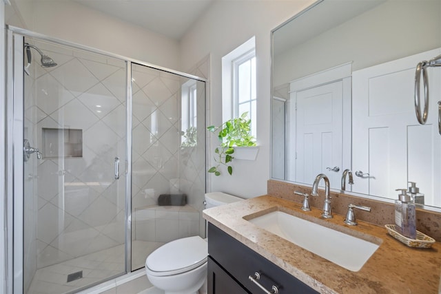 full bathroom with toilet, a stall shower, and vanity