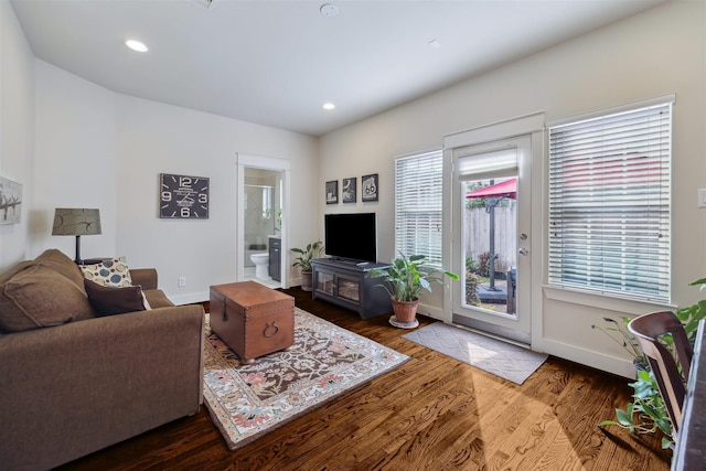 living room with recessed lighting, baseboards, and wood finished floors