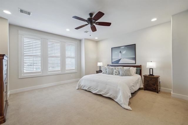 bedroom featuring light carpet, visible vents, and baseboards