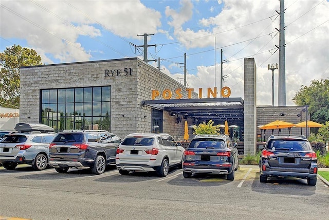 view of building exterior featuring uncovered parking