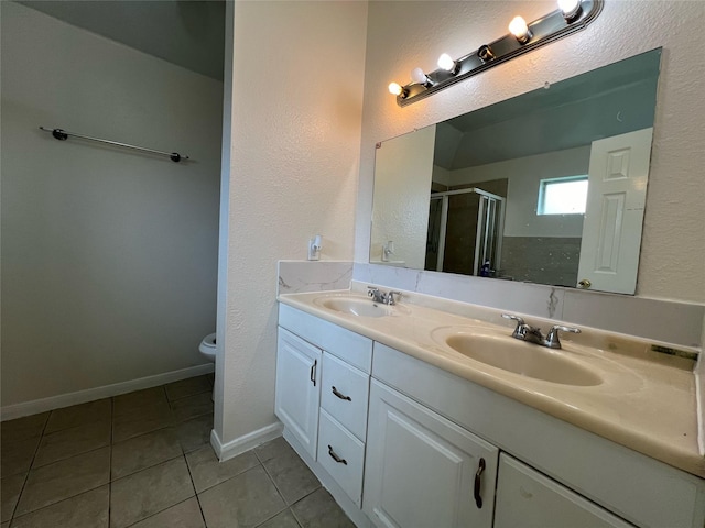 full bath with tile patterned floors, double vanity, a stall shower, and a sink