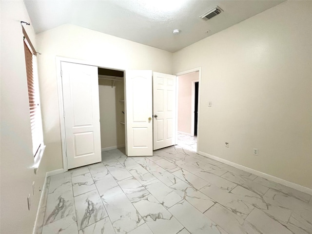 unfurnished bedroom with visible vents, marble finish floor, a closet, and baseboards