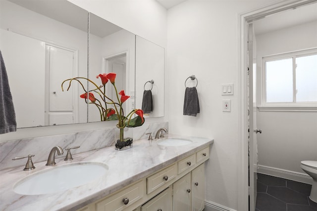 18531 Point Lookout Dr, Houston, TX 77058 - bathroom with double vanity, toilet, tile patterned flooring, and baseboards