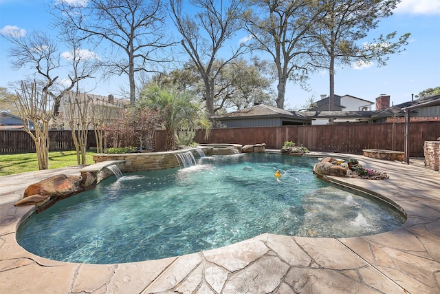 view of swimming pool featuring a jacuzzi, a patio, a fenced in pool, and a fenced backyard