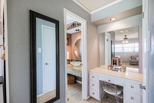 bathroom featuring visible vents, a textured ceiling, a ceiling fan, and a sink