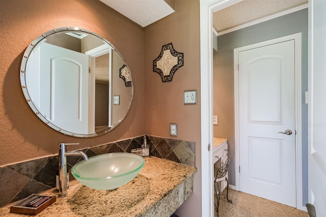 bathroom featuring a textured ceiling and a sink