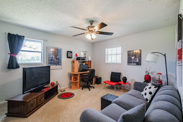 carpeted living area featuring a wealth of natural light, a textured ceiling, and ceiling fan