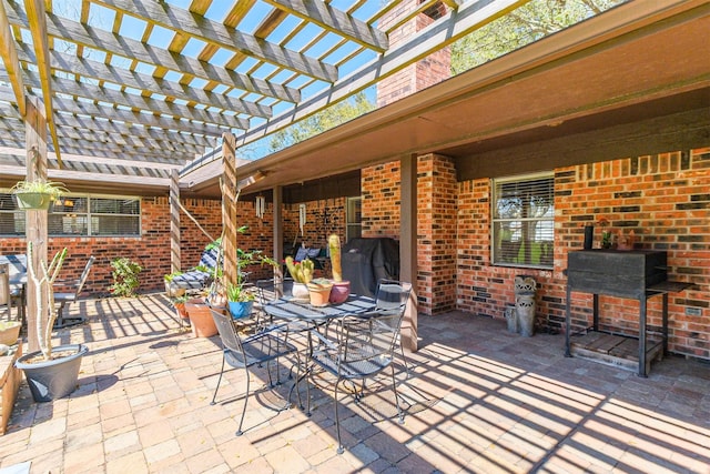 view of patio / terrace with outdoor dining space and a pergola