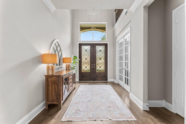 entryway featuring wood finished floors, french doors, and baseboards