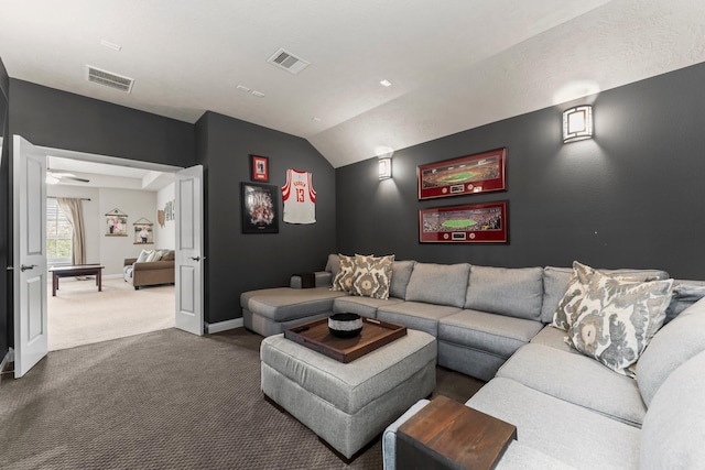 living room with visible vents, dark carpet, baseboards, and vaulted ceiling