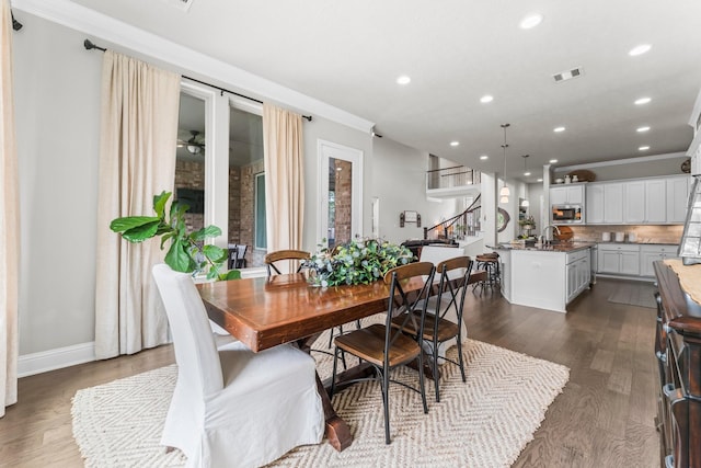 dining room with stairway, visible vents, recessed lighting, dark wood-style flooring, and ornamental molding