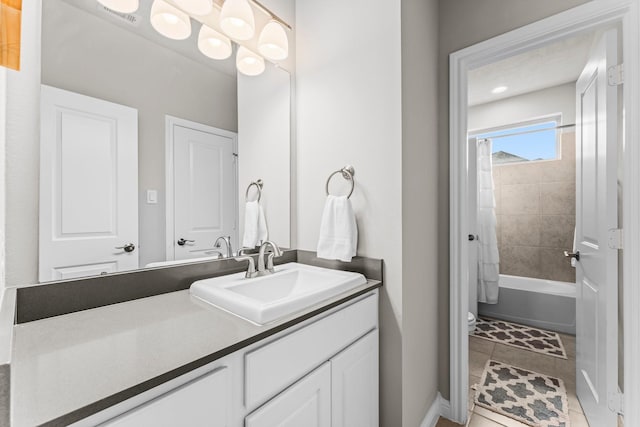 bathroom with visible vents, shower / bath combo with shower curtain, and vanity