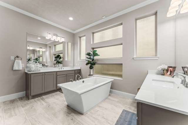 full bath with ornamental molding, two vanities, baseboards, and a sink