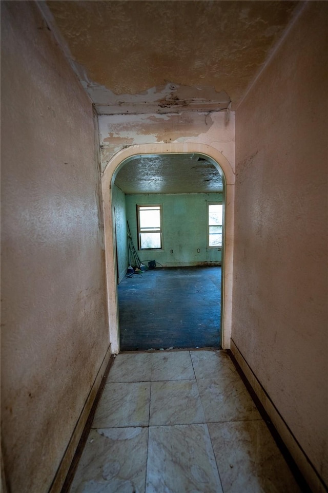 hallway featuring arched walkways