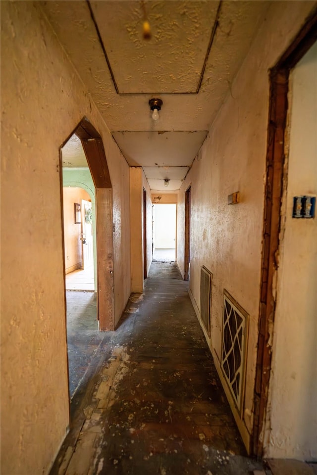 corridor with arched walkways and visible vents