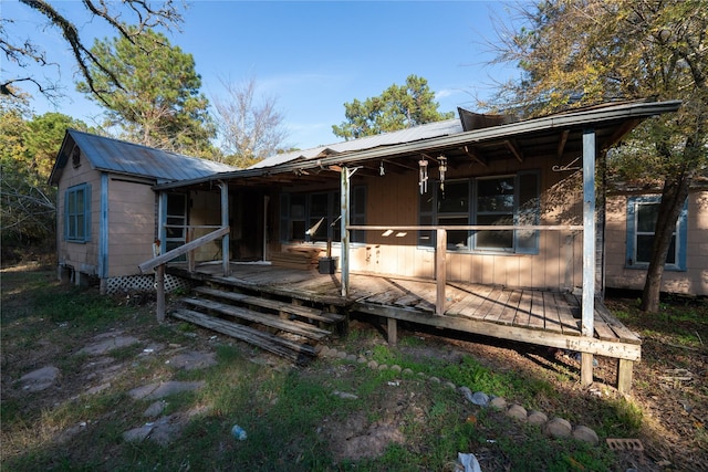 rear view of property with metal roof