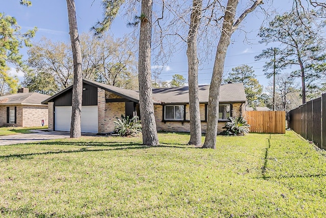 view of front of property featuring fence, concrete driveway, an attached garage, a front yard, and brick siding