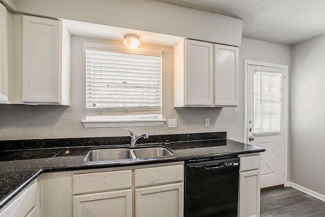 kitchen with wood finished floors, baseboards, white cabinetry, a sink, and dishwasher