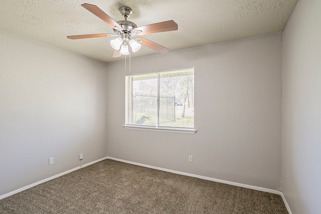 carpeted empty room featuring ceiling fan, a textured ceiling, and baseboards