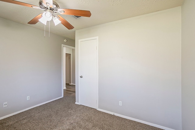 unfurnished room featuring ceiling fan, baseboards, carpet floors, and a textured ceiling