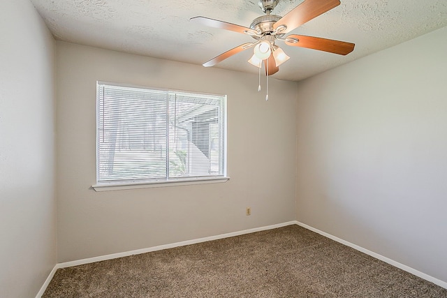 empty room with carpet flooring, a textured ceiling, baseboards, and a ceiling fan