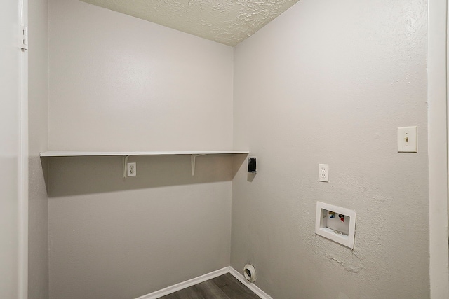 clothes washing area featuring washer hookup, a textured ceiling, dark wood-style floors, baseboards, and laundry area