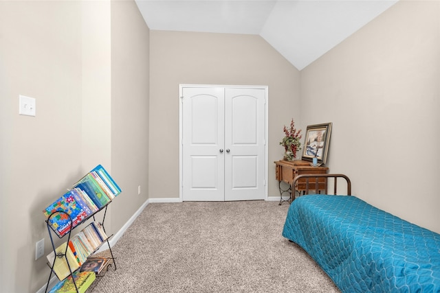 bedroom featuring vaulted ceiling, a closet, baseboards, and carpet floors