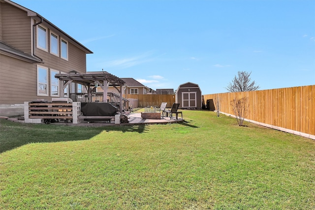 view of yard with an outbuilding, a shed, a fenced backyard, a pergola, and a patio area