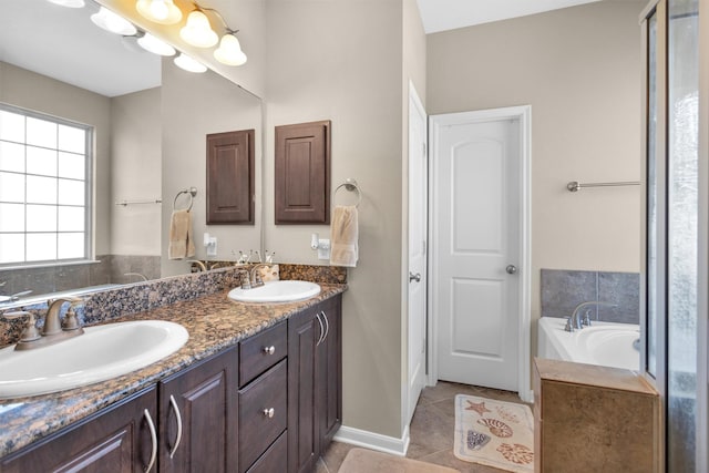 full bathroom featuring a sink, a bath, double vanity, and tile patterned flooring