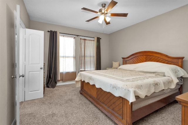 bedroom with light colored carpet and a ceiling fan