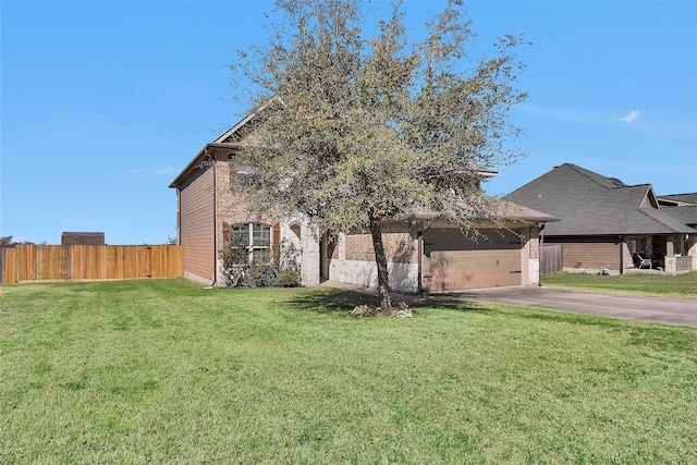 view of front facade featuring a garage, driveway, a front yard, and fence