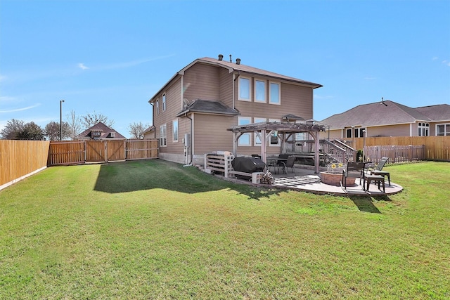 rear view of property with a gate, a fire pit, a fenced backyard, and a patio area