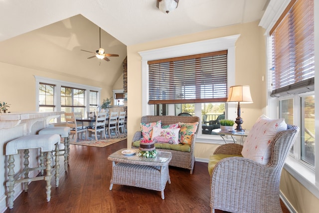 living room featuring a wealth of natural light, lofted ceiling, a ceiling fan, and wood finished floors