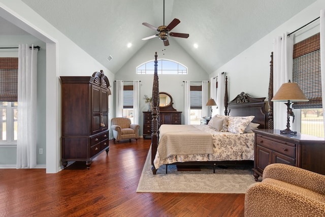 bedroom with visible vents, high vaulted ceiling, a ceiling fan, baseboards, and dark wood-style flooring