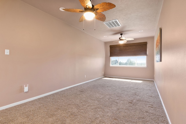 spare room featuring visible vents, baseboards, carpet floors, a textured ceiling, and a ceiling fan