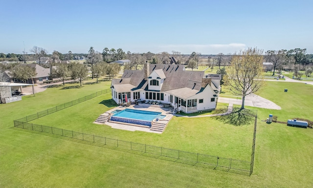 exterior space with a yard, a patio area, a pool with connected hot tub, and a fenced backyard