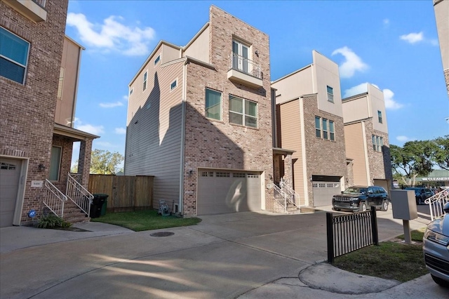 view of front of house featuring concrete driveway, an attached garage, and brick siding