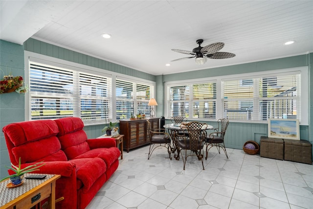 sunroom with plenty of natural light and a ceiling fan