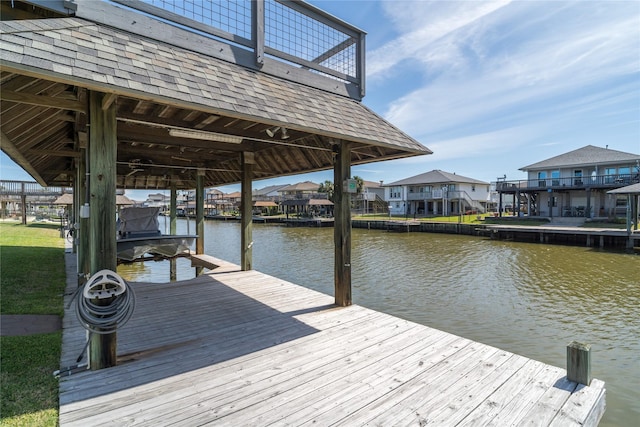 dock area with a residential view and a water view