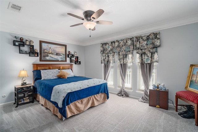 bedroom featuring visible vents, crown molding, ceiling fan, baseboards, and carpet