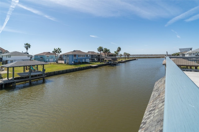 view of dock featuring a residential view and a water view