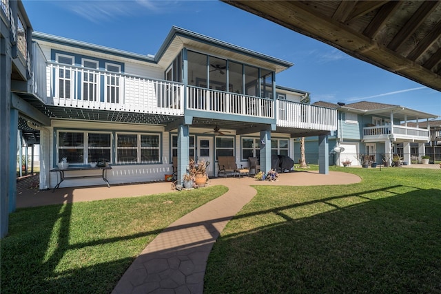 rear view of house featuring a yard, a patio, ceiling fan, and a sunroom