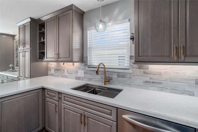 kitchen with open shelves, a sink, pendant lighting, stainless steel dishwasher, and tasteful backsplash