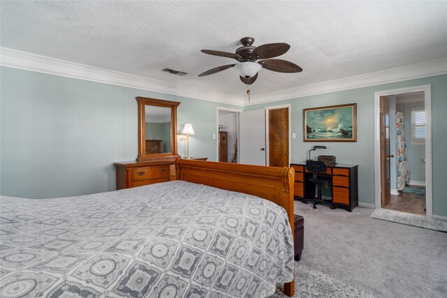 bedroom with visible vents, carpet flooring, a textured ceiling, and ornamental molding