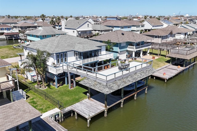 drone / aerial view featuring a residential view and a water view