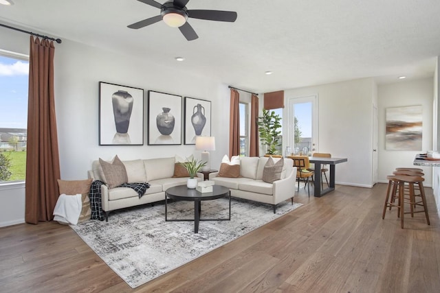 living room with recessed lighting, wood finished floors, and baseboards