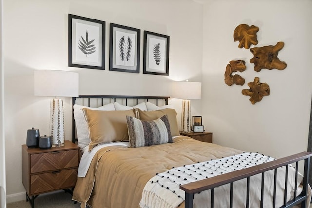 bedroom featuring baseboards and carpet