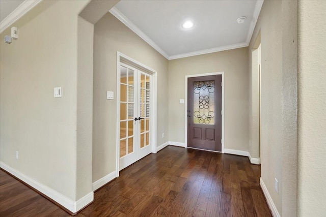 entryway with arched walkways, dark wood finished floors, baseboards, and ornamental molding